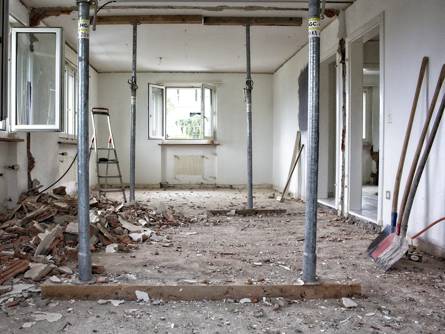 Before: a room stripped back to bare walls with props and rubble on the floor