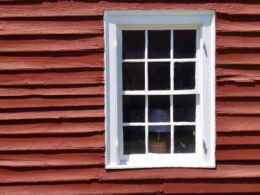 After: the same siding scraped, primed and repainted with crisp white trim